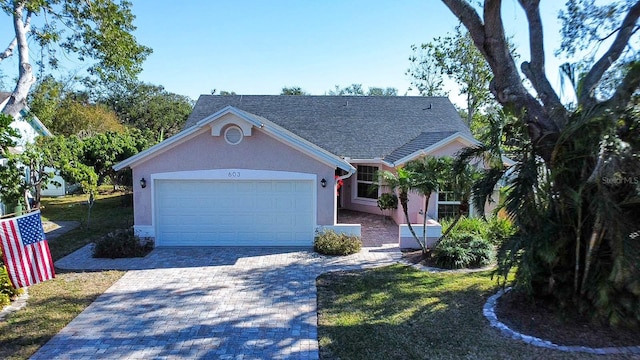 view of front of property featuring a garage and a front lawn