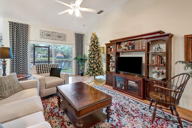 living room with light wood-type flooring, ceiling fan, and lofted ceiling