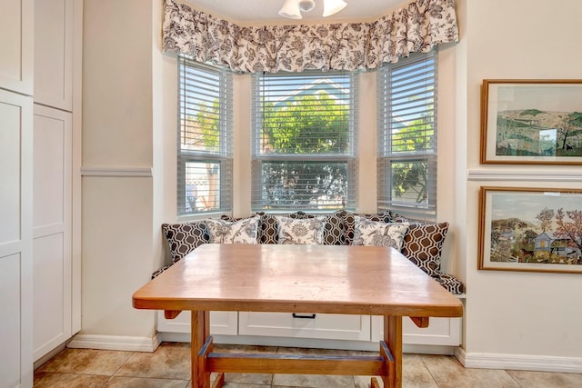 dining area featuring light tile patterned floors and breakfast area