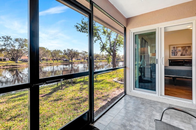 unfurnished sunroom with a water view