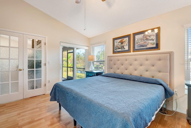 bedroom with vaulted ceiling, access to exterior, wood-type flooring, and french doors