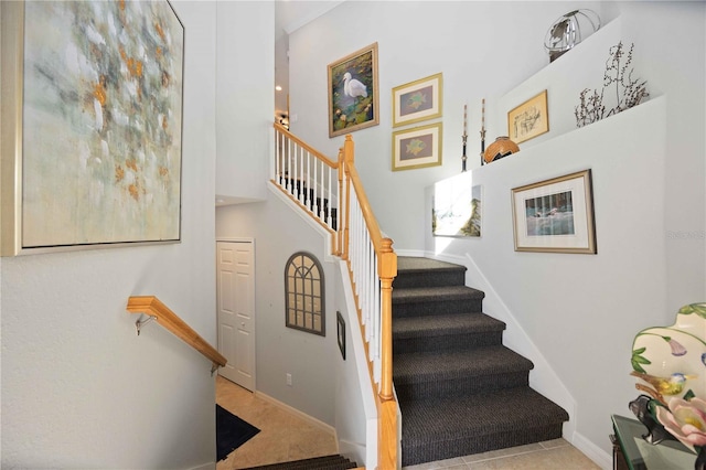 stairs featuring tile patterned flooring