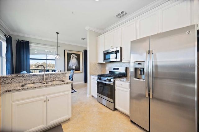 kitchen featuring white cabinets, stainless steel appliances, light stone countertops, and sink