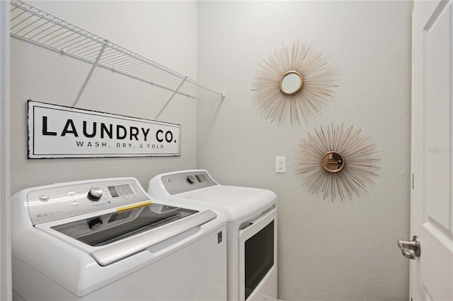 laundry room featuring washing machine and clothes dryer