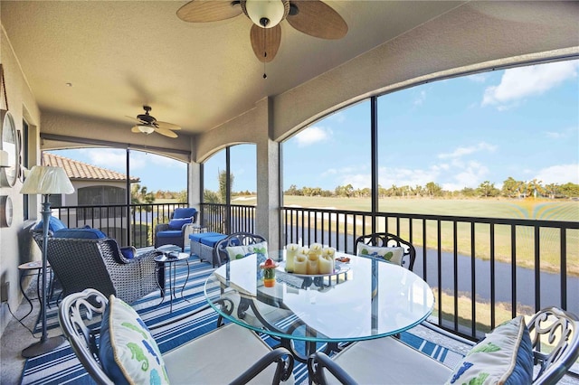 sunroom / solarium featuring ceiling fan