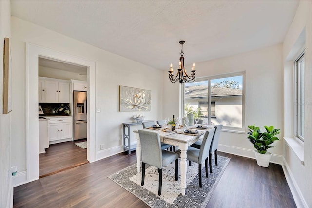 dining room with a notable chandelier and dark hardwood / wood-style floors