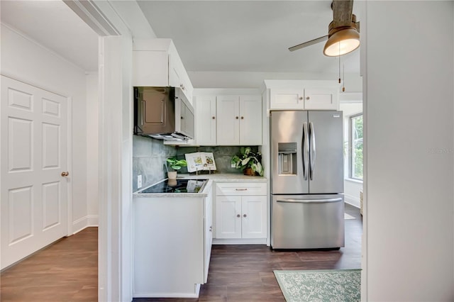 kitchen featuring black electric stovetop, white cabinetry, stainless steel fridge with ice dispenser, and backsplash