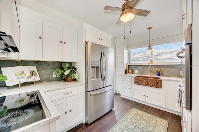 kitchen featuring white cabinetry, backsplash, stainless steel fridge with ice dispenser, and sink