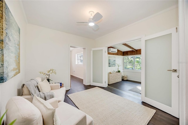 living area with beamed ceiling, dark hardwood / wood-style floors, a wall mounted AC, and ceiling fan