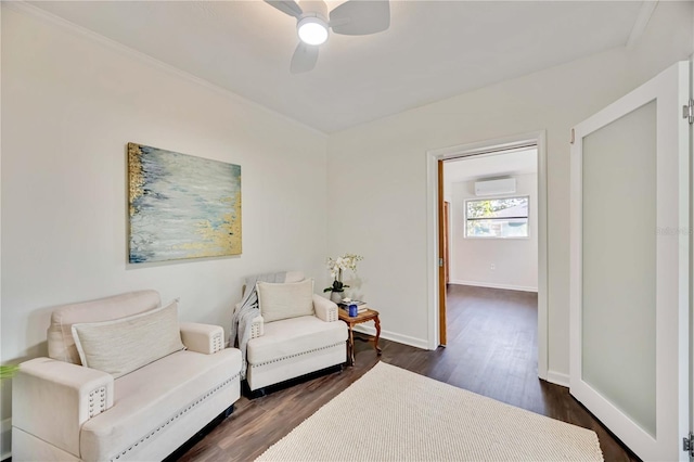 living area with ceiling fan, an AC wall unit, and dark wood-type flooring