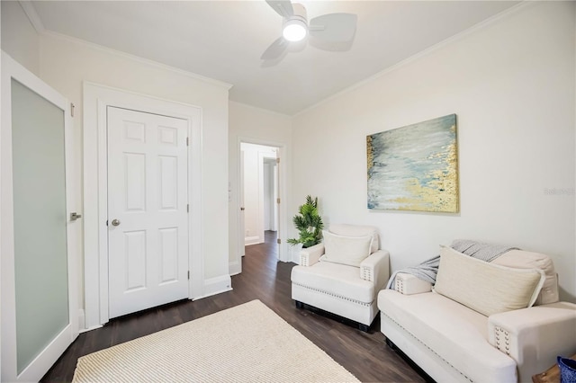 sitting room featuring ornamental molding, ceiling fan, and dark wood-type flooring