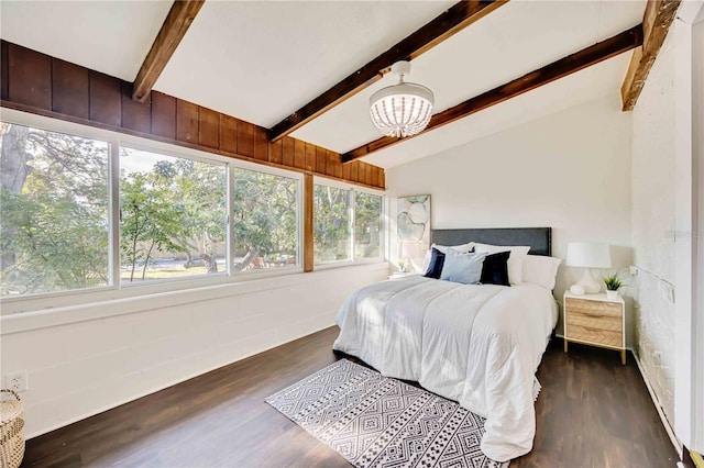 bedroom with a notable chandelier, vaulted ceiling with beams, and dark hardwood / wood-style floors