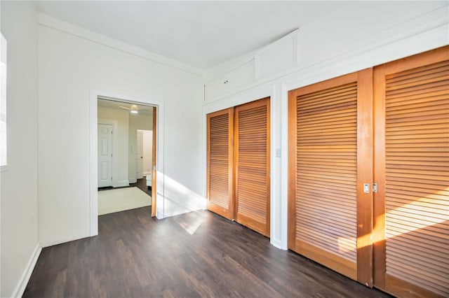 unfurnished bedroom featuring dark wood-type flooring