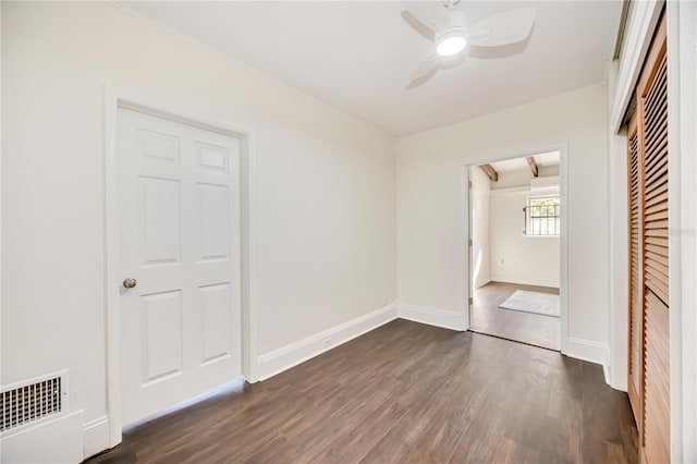 unfurnished bedroom with ceiling fan, a closet, and dark hardwood / wood-style floors