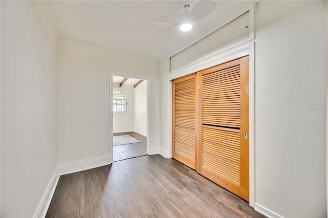 unfurnished bedroom featuring hardwood / wood-style floors, a closet, and ceiling fan