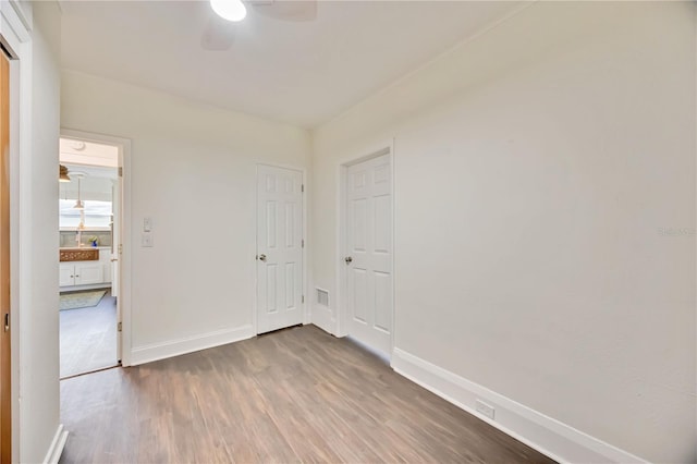 unfurnished room with hardwood / wood-style floors and ceiling fan