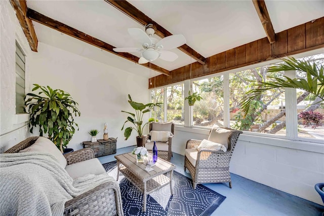 sunroom featuring beamed ceiling and ceiling fan