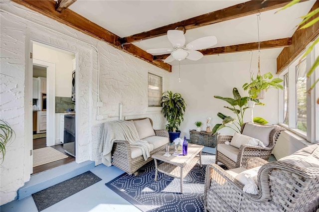 sunroom / solarium with beam ceiling and ceiling fan