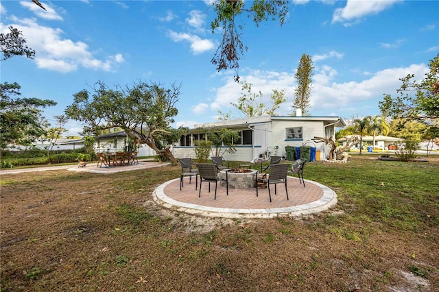 rear view of house with a lawn and a patio area