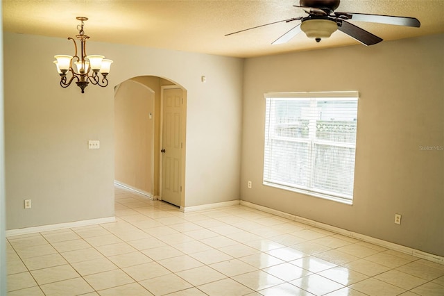 731 Cristelle Jean Dr, Ruskin, FL 33570 - unfurnished room with a ceiling fan, a textured ceiling, light tile patterned floors, baseboards, and arched walkways