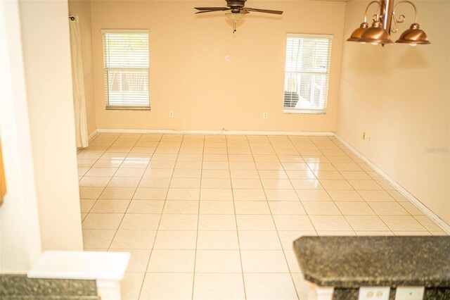 731 Cristelle Jean Dr, Ruskin, FL 33570 - empty room with plenty of natural light, a ceiling fan, and light tile patterned floors