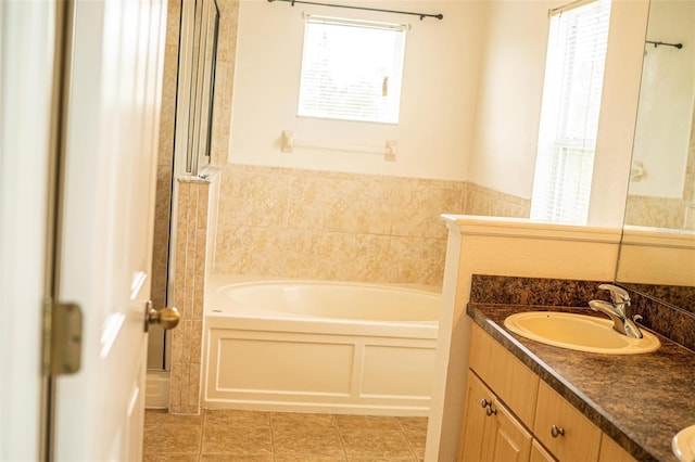 731 Cristelle Jean Dr, Ruskin, FL 33570 - full bath featuring double vanity, plenty of natural light, a sink, and a garden tub