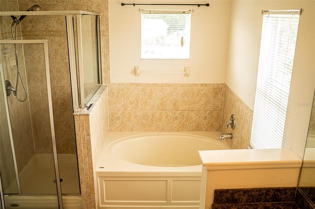 731 Cristelle Jean Dr, Ruskin, FL 33570 - full bathroom featuring a stall shower and a garden tub