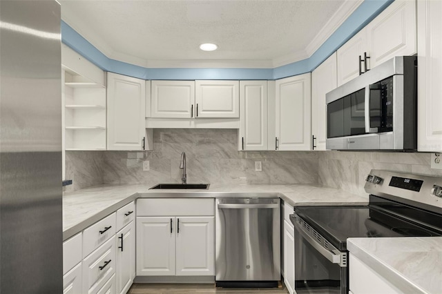 kitchen featuring tasteful backsplash, appliances with stainless steel finishes, sink, and white cabinets