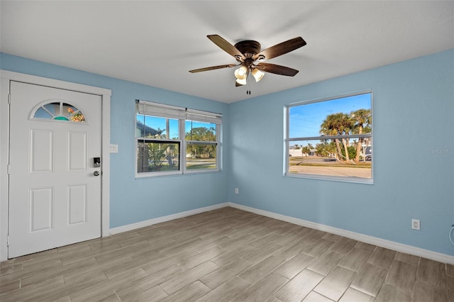 foyer with ceiling fan and light wood-type flooring