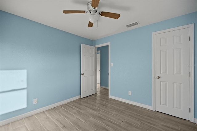 unfurnished bedroom featuring ceiling fan and light wood-type flooring