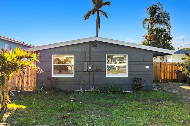 view of side of home with a lawn