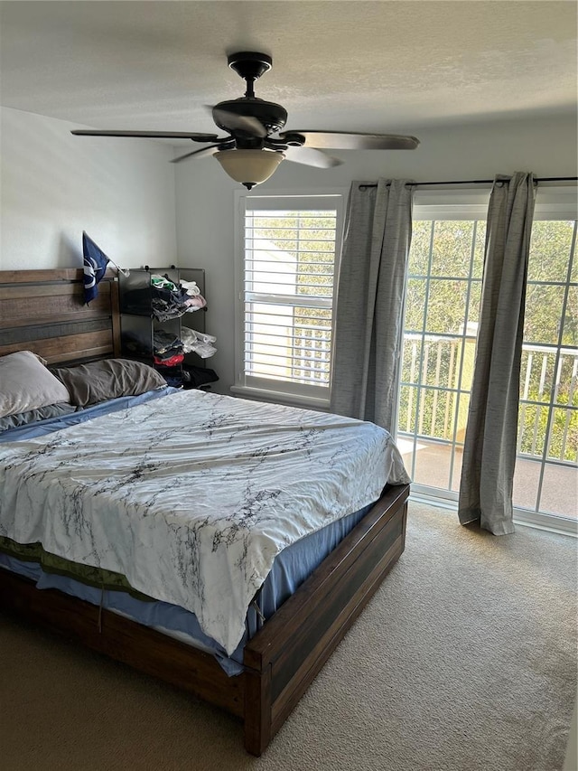 carpeted bedroom with access to outside and ceiling fan