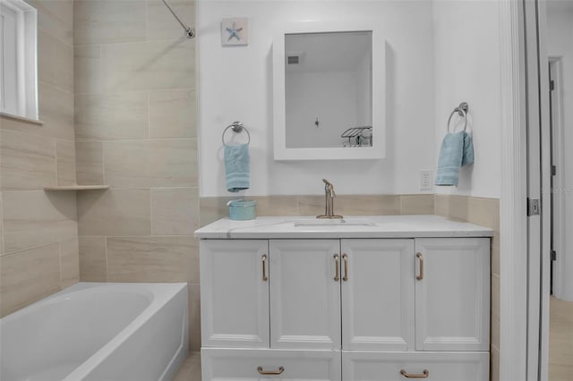 bathroom featuring vanity and tiled shower / bath combo