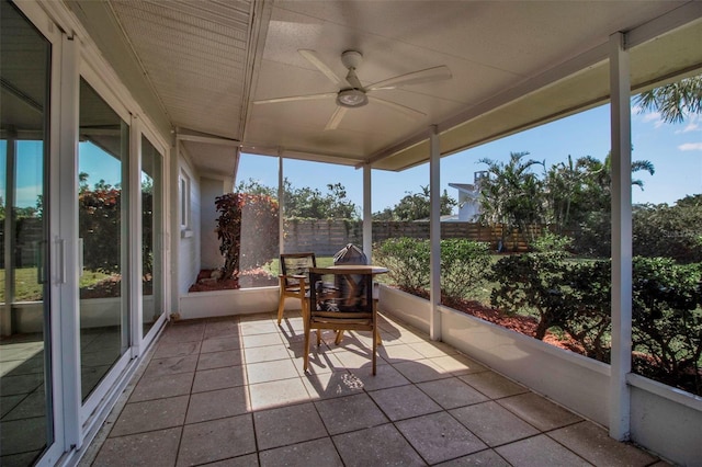 unfurnished sunroom with ceiling fan and a healthy amount of sunlight