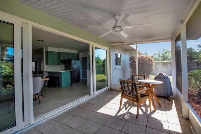 sunroom featuring ceiling fan