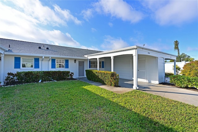 single story home with concrete driveway, an attached carport, roof with shingles, a front yard, and stucco siding