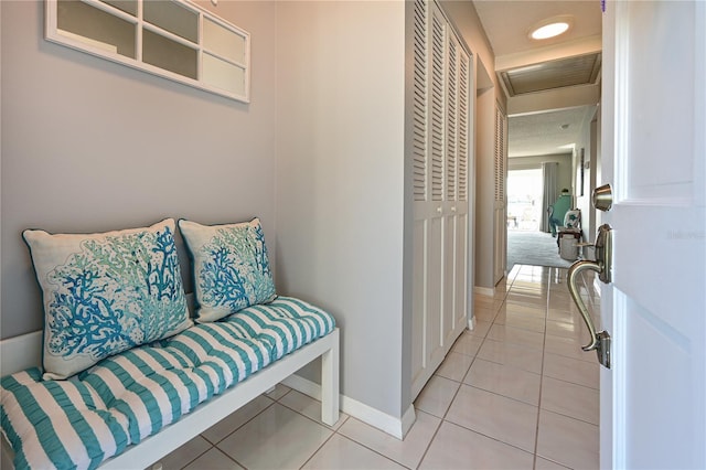 interior space featuring light tile patterned floors and baseboards