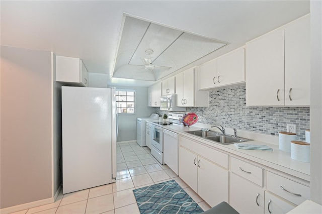 kitchen with light countertops, white appliances, a sink, and white cabinetry