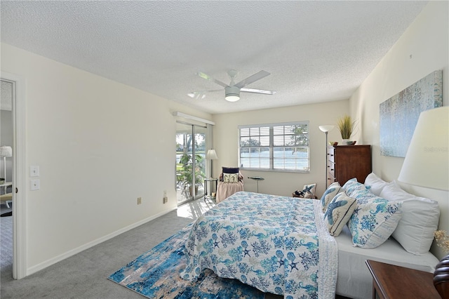 carpeted bedroom featuring a textured ceiling, access to outside, a ceiling fan, and baseboards