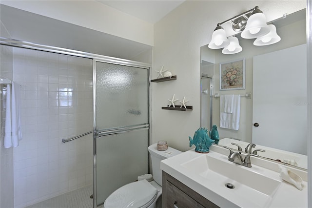 full bath featuring vanity, toilet, and a shower stall