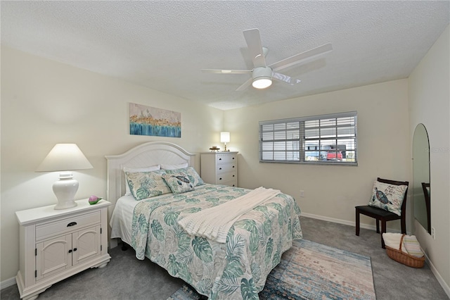 carpeted bedroom featuring a textured ceiling, ceiling fan, and baseboards