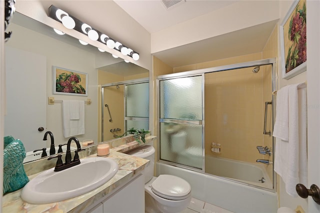 full bathroom with visible vents, vanity, toilet, and combined bath / shower with glass door