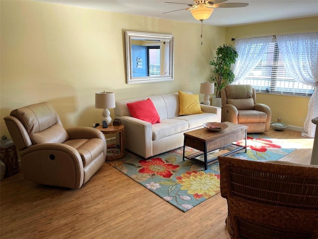 living room featuring ceiling fan and wood-type flooring