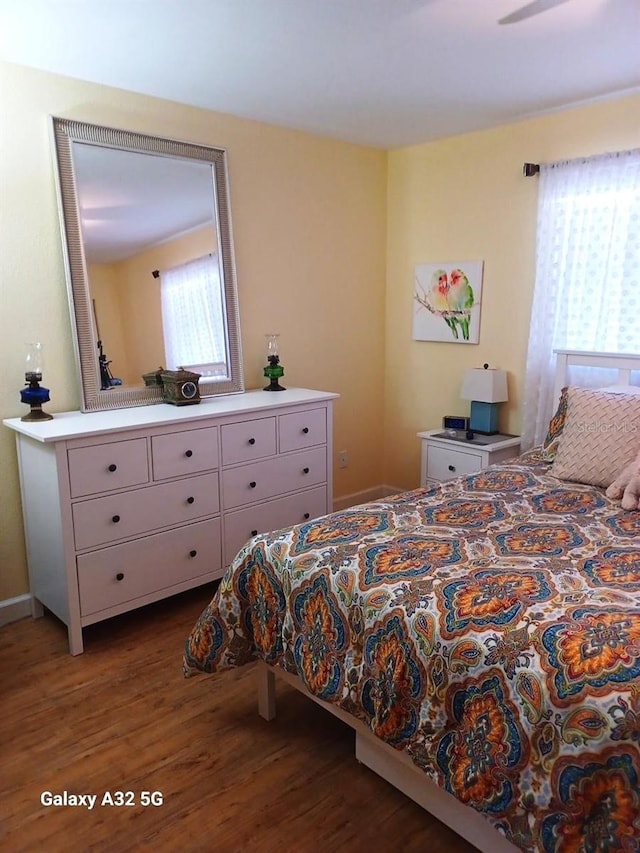 bedroom featuring hardwood / wood-style flooring and ceiling fan