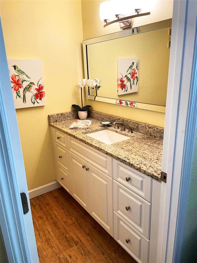 bathroom featuring vanity and hardwood / wood-style flooring