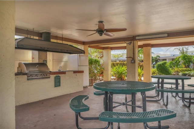 view of patio featuring an outdoor kitchen, ceiling fan, and a grill