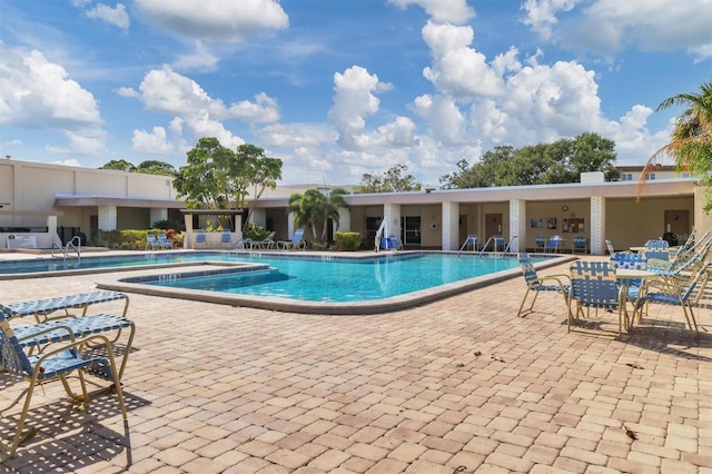 view of swimming pool with a patio