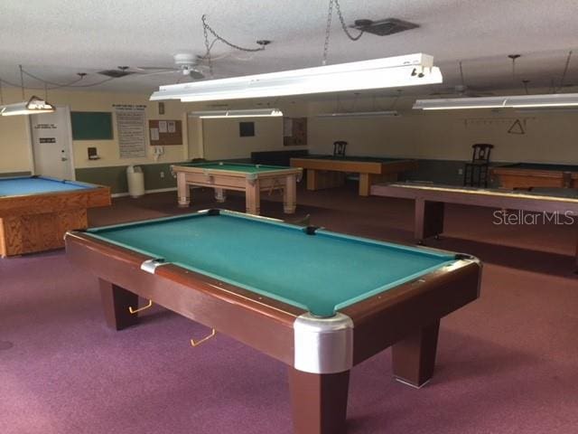 game room with carpet, a textured ceiling, and pool table