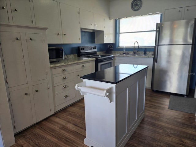 kitchen featuring white cabinets, dark hardwood / wood-style floors, sink, and stainless steel appliances