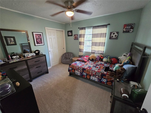 carpeted bedroom featuring a textured ceiling, a closet, and ceiling fan